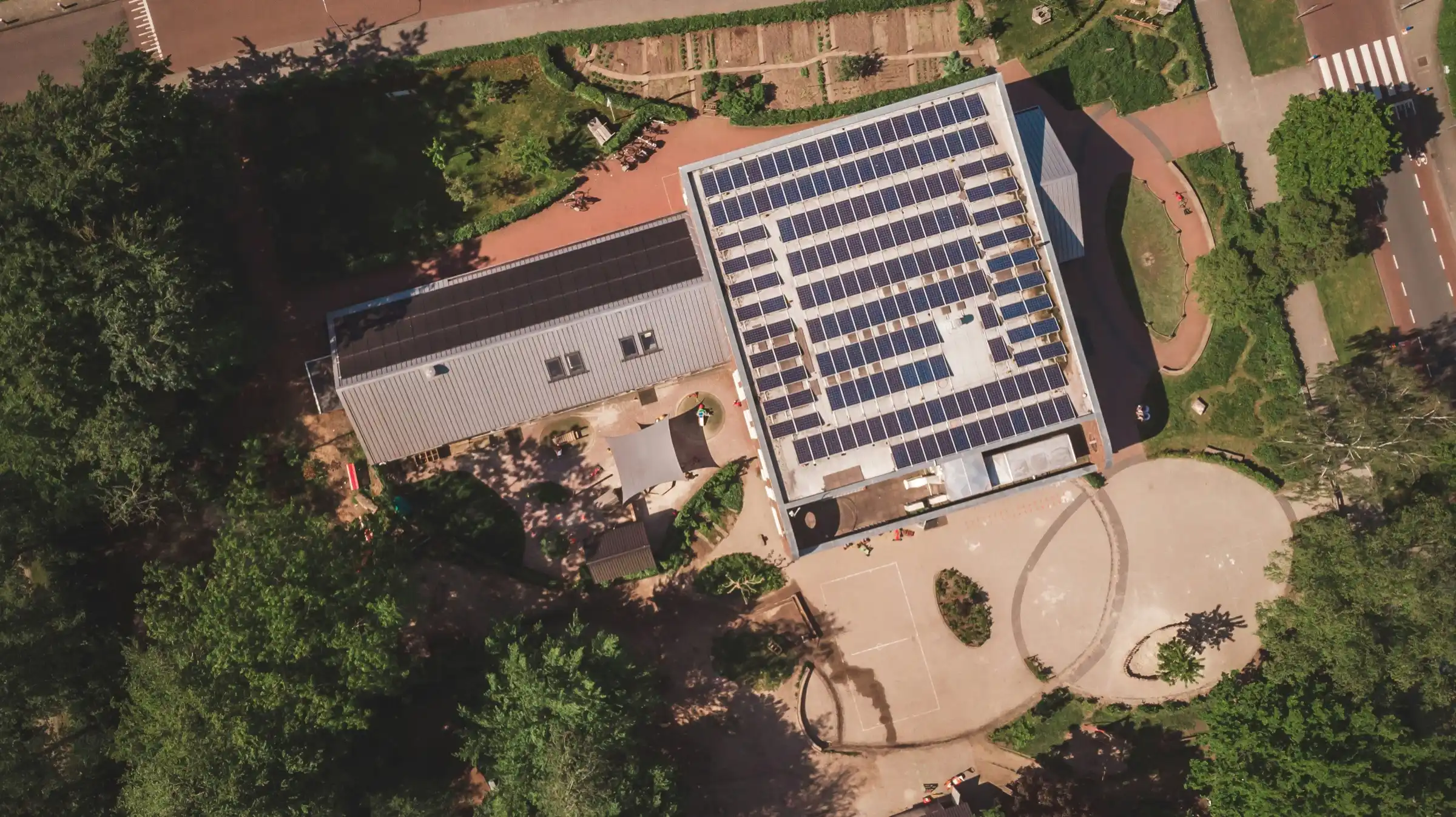 Top-down view of a business roof covered in solar panels