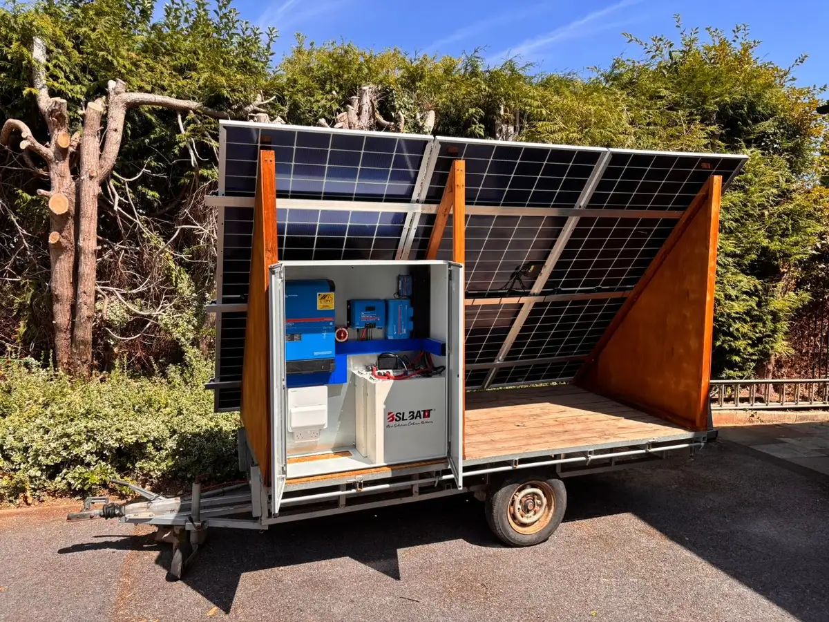 Trailer-mounted solar array with a Victron inverter and lithium battery cabinet in Devon, built by Quanta
