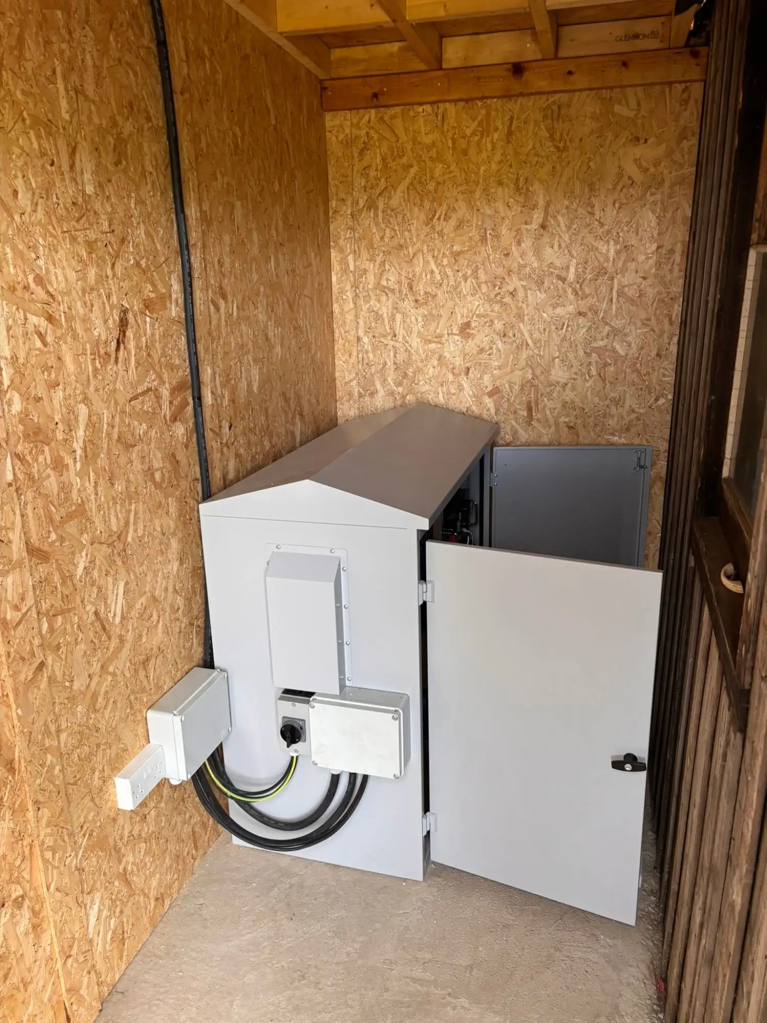 Weatherproof battery and inverter cabinet installed in a timber shed