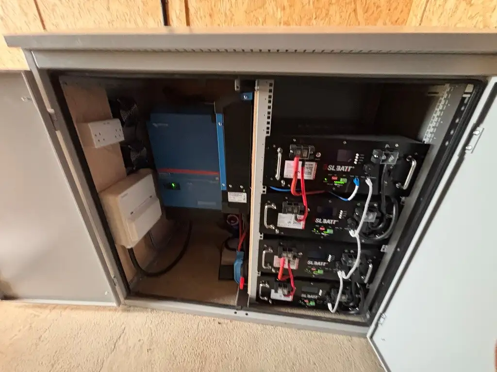 Inside the cabinet: a Victron inverter and a rack of lithium battery modules